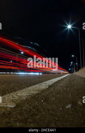 Vertical shot of the light trails on the road at night. Stock Photo