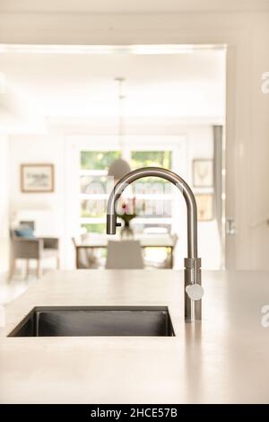 Metal faucet over sink modern kitchen Stock Photo