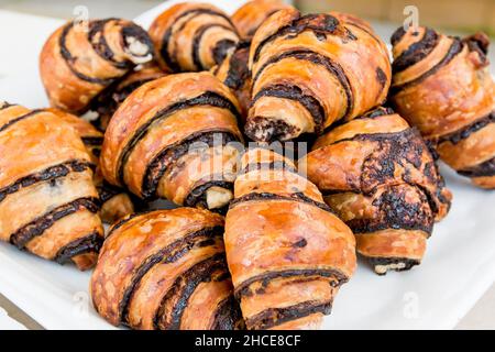Rugelach (other spellings: rugelakh, rugulach, rugalach, ruggalach, rogelach (all plural), rugalah, rugala (singular)) is a Jewish pastry of Ashkenazi Stock Photo