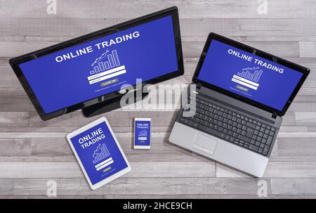 Online trading concept shown on different information technology devices Stock Photo