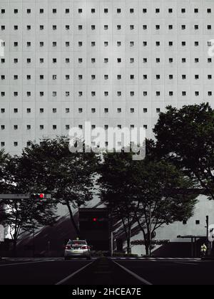 Vertical shot of modern architecture. The car against the modern building. Stock Photo