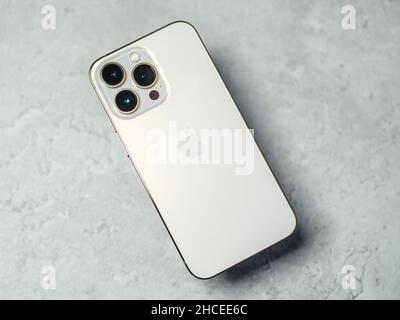 HCMC, Vietnam - August 19, 2021: View of new iPhone 13 or iPhone 13 Pro and Apple Airpods for editorial use Stock Photo