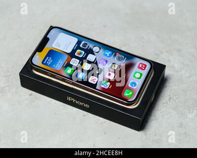 HCMC, Vietnam - August 19, 2021: View of new iPhone 13 or iPhone 13 Pro and Apple Airpods for editorial use Stock Photo