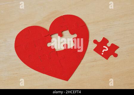 Heart shaped puzzle with missing piece - Concept of love and troubles Stock Photo