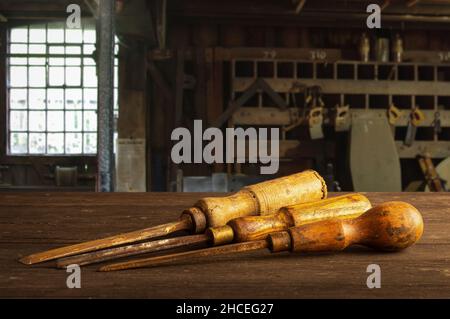 Three old wood chisels in a carpenters workshop Stock Photo
