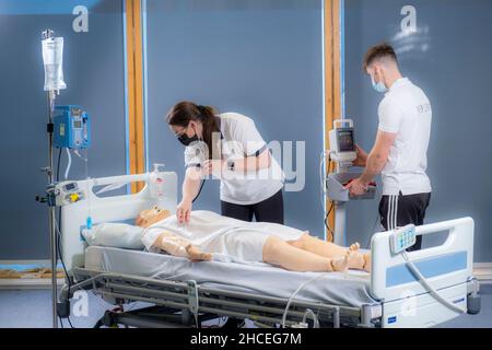 Student nurses training realistic medical dummy Stock Photo