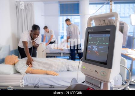 Student nurses training realistic medical dummy Stock Photo