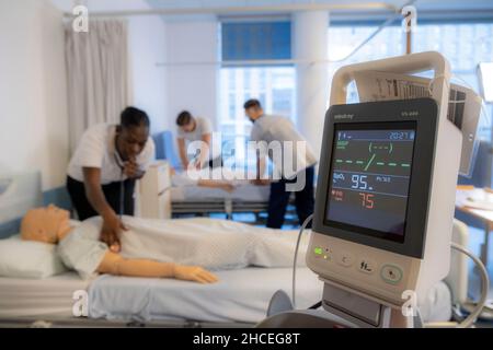 Student nurses training realistic medical dummy Stock Photo