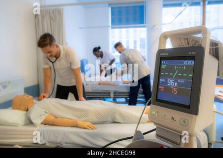 Student nurses training realistic medical dummy Stock Photo