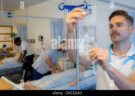 Student nurses training realistic medical dummy Stock Photo