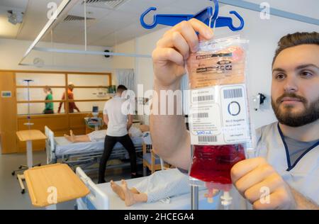 Student nurses training realistic medical dummy Stock Photo