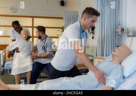 Student nurses training realistic medical dummy Stock Photo