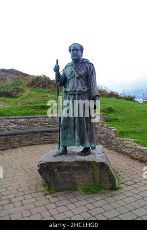 St Carannog statue above village of Llangrannog, Wales Stock Photo