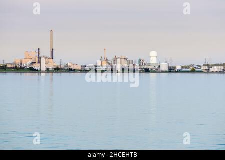 Chemical plant along a river on a cloudy autumn day Stock Photo