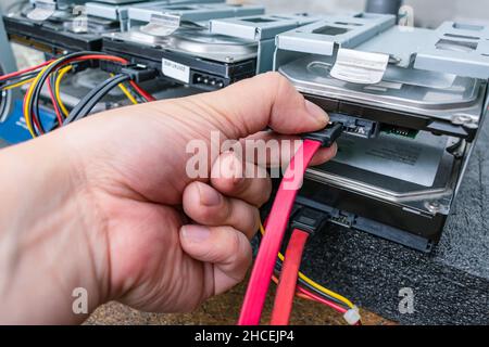 Service engineer maintains servers with data on hard drives Stock Photo