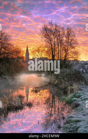 The first rays of an early March sunrise light up the sky over the Wiltshire hillside town of Malmesbury.