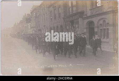 The Bliss Tweed Mill Strike, Chipping Norton, 1913-1914: striking men marching along the road during an industrial dispute at a local textile company. The photograph was taken by local photographer Frank Packer and sold as a postcard Stock Photo