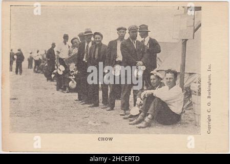 'Chow': queue of unemployed ex-servicemen with mess tins, sitting and standing next to tents. The image shows one of the shanty towns built by members of the 1932 'Bonus Army' during the Great Depression in the USA. They were protesting to obtain the 'tombstone bonus' promised in 1924 to American veterans of the First World War (distribution of the bonus had been deferred until 1945) Stock Photo