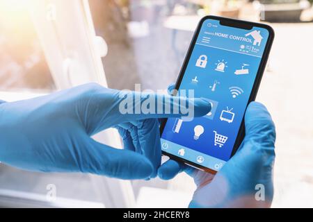 smart home app in coronavirus quarantine to unlock the door of his house. smart home technology interface in a smartphone screen application. Stock Photo