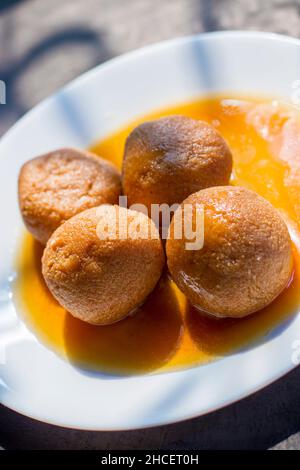 sugar filled roll, commonly known as 'Rasgulla' or ' Nolen Gurer Rosogolla' in Bengali is made of new Jaggery and Curd. Stock Photo