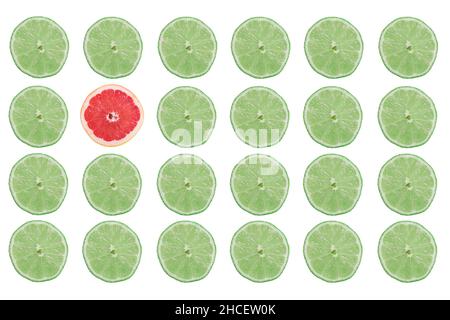Rows of lime fruit slices and only one grapefruit slice isolated on a white background Stock Photo