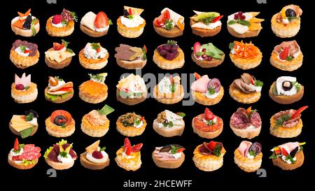 Canapes with different berries and toppings isolated on a black background Stock Photo