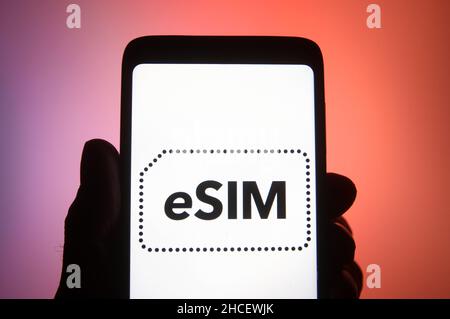 Ukraine. 27th Dec, 2021. In this photo illustration, eSIM word, name of an embedded integrated programmable SIM card that is embedded directly into a mobile phone, is seen on a smartphone. (Credit Image: © Pavlo Gonchar/SOPA Images via ZUMA Press Wire) Stock Photo