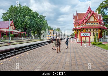 Train leaving the iconic Hua Hin Railway Station and Royal Pavilion. Hua Hin is one of the first and most popular travel destinations in Thailand. Stock Photo
