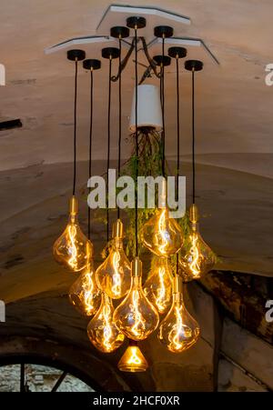Decorative antique edison style filament light bulbs hanging from the ceiling. Stock Photo
