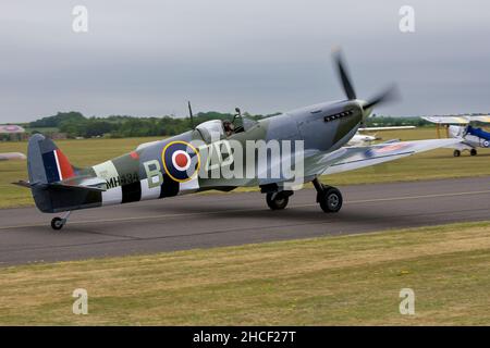 Supermarine Spitfire Mk IXb (G-ASJV) taxiing on the runway at Duxford preparing to take part in the Daks over Normandy airshow on the 4th June 2019 Stock Photo