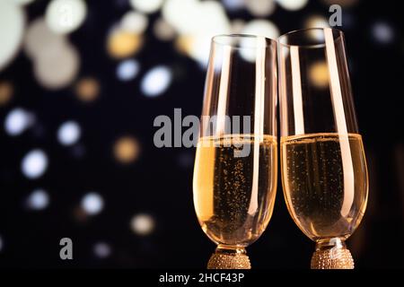 happy New Year champagne glasses and fireworks celebration background Stock Photo