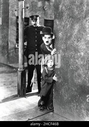 The Kid with Charlie Chaplin as the Tramp, Jackie Coogan as The Child and Tom Wilson as the Cop - 1921 Stock Photo