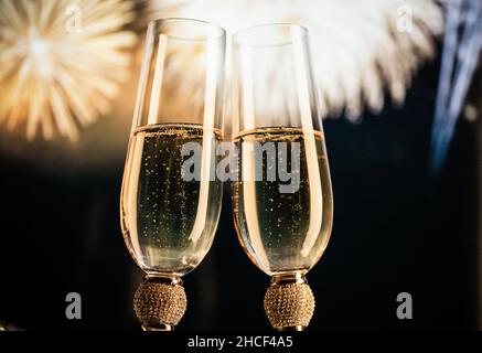 happy New Year champagne glasses and fireworks celebration background Stock Photo