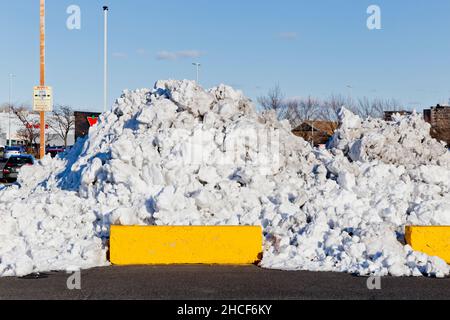 A pile of cleared snow in a mall car park in Longueuil, Quebec, Canada Stock Photo