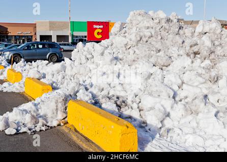 A pile of cleared snow in a mall car park in Longueuil, Quebec, Canada Stock Photo