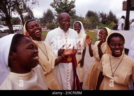 Bishop Moses Anderson, first African American Bishop in Detroit Catholic Archdiocese, laughs with nuns on one of his trips to Ghana in West Africa. Stock Photo