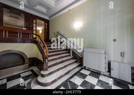 Marble stairs going up to residential homes and stair lifts for wheelchairs Stock Photo