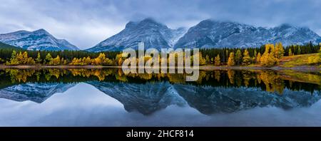 Panoramic View of Mount Kidd and Surround Areas Reflecting in Wedge Pond during a Fall Foggy Morning. Stock Photo