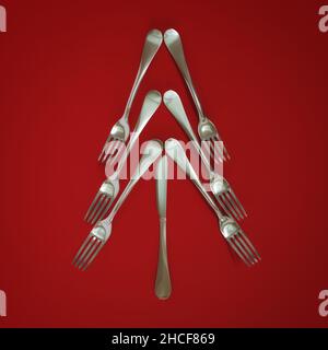 Christmas tree made from forks and knife on red background, flat lay, top view, 3D render Stock Photo