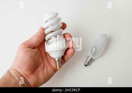 Burnt out energy-saving lamps on a white background Stock Photo