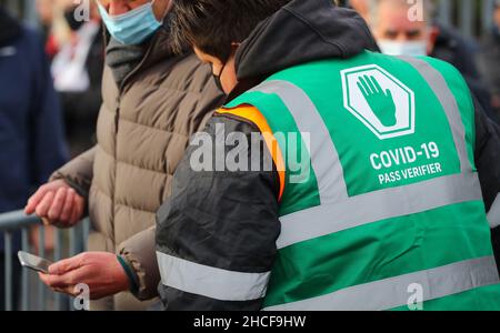 Covid Pass wardens inspect covid passports of football fans as they attend a UK Premier League football match in Southampton, UK. Stock Photo