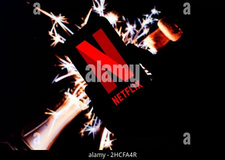 Poland. 21st Dec, 2021. In this photo illustration a Netflix logo seen displayed on a smartphone and Christmas decorations in the background. (Photo by Filip Radwanski/SOPA Images/Sipa USA) Credit: Sipa USA/Alamy Live News Stock Photo