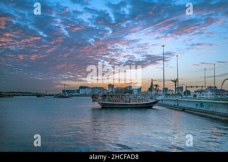 Sunrise view of Corniche Beach with Dhow boat Stock Photo - Alamy