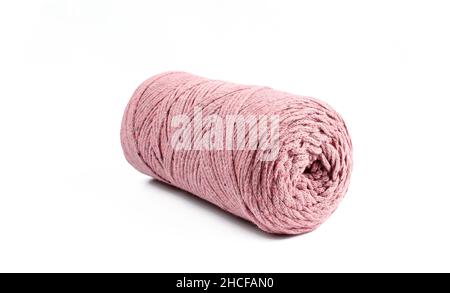 Roll of pink thread for knitting isolated on white background. Macrame Stock Photo