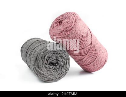 Grey and pink thread rolls for knitting isolated on white background. Macrame Stock Photo