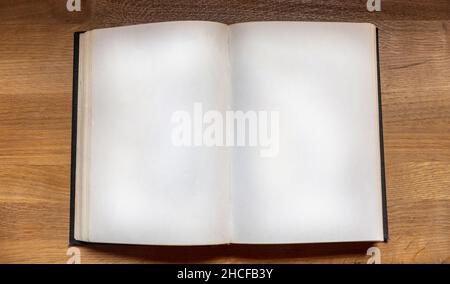 Open notebook on wooden background, top view. Blank book page on a table. Copy space, note template Stock Photo