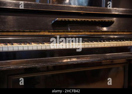 Piano keys on old wooden musical instrument. Piano keyboard closeup view, classic music and classical musical event concept Stock Photo