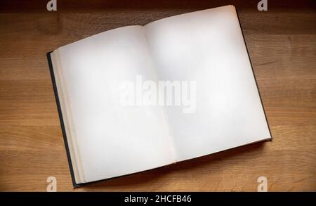 Open notebook on wooden background, top view. Blank book page on a table. Copy space, note template Stock Photo