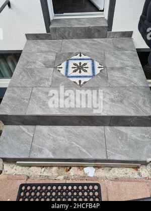 Laying ceramic floor tiles - man hands closeup Stock Photo