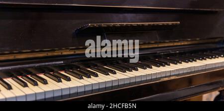 Piano keyboard on old wooden musical instrument. Piano keys closeup view, classic music and classical musical event concept Stock Photo